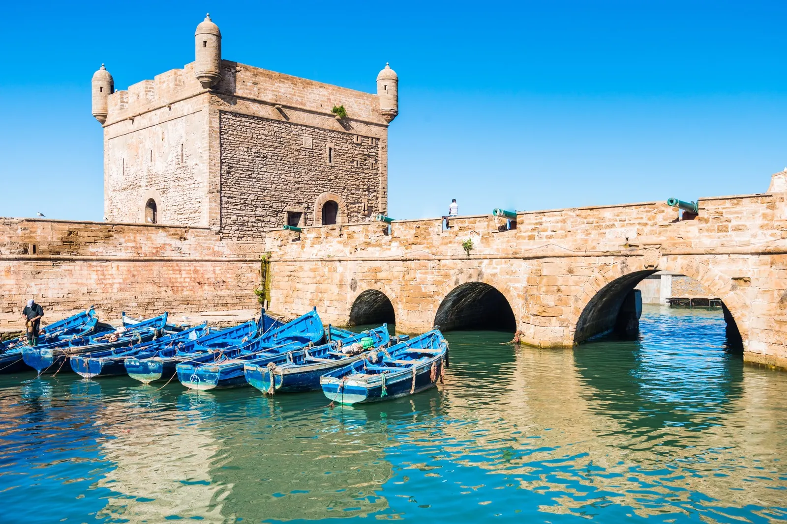 &Olives_Morocco_Fort of Essaouira in Morocco on a sunny day with blue boats on the water and selective focus