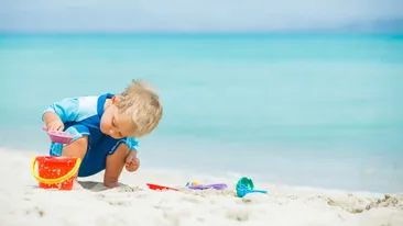 jongetje speelt op het strand