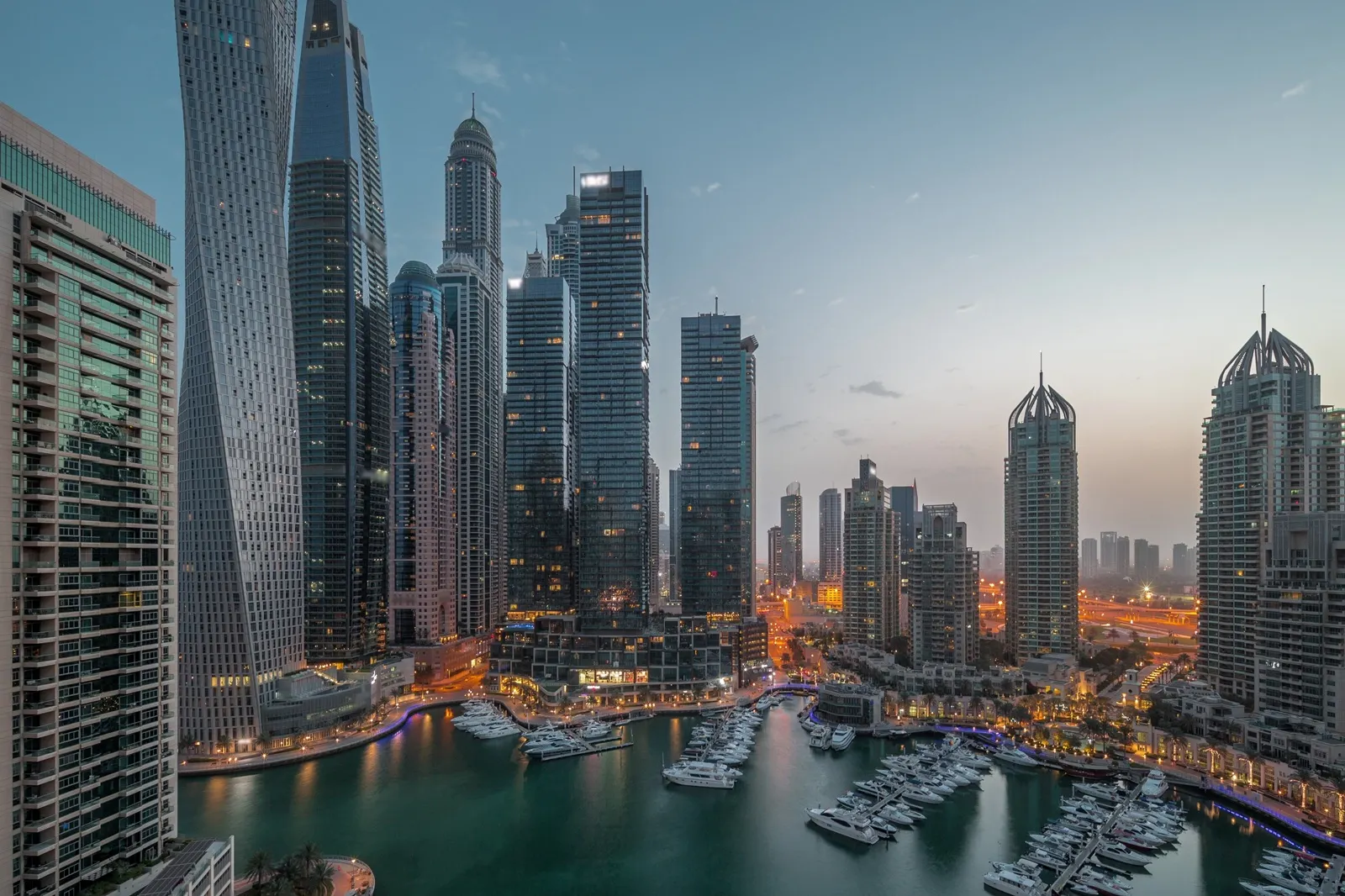 Dubai marina tallest skyscrapers and yachts in harbor, UAE